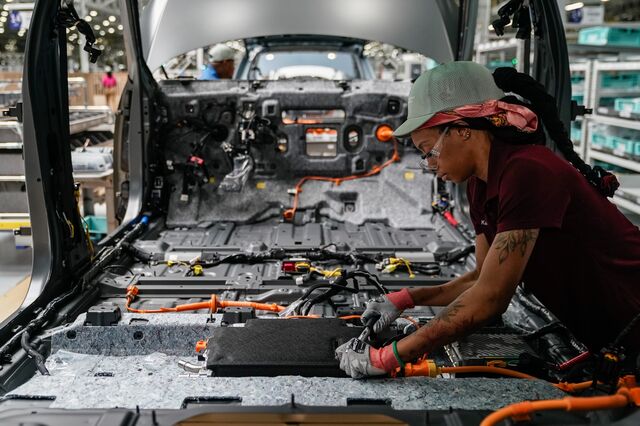 An employee works on a vehicle on the production floor at the Hyundai Metaplant. 