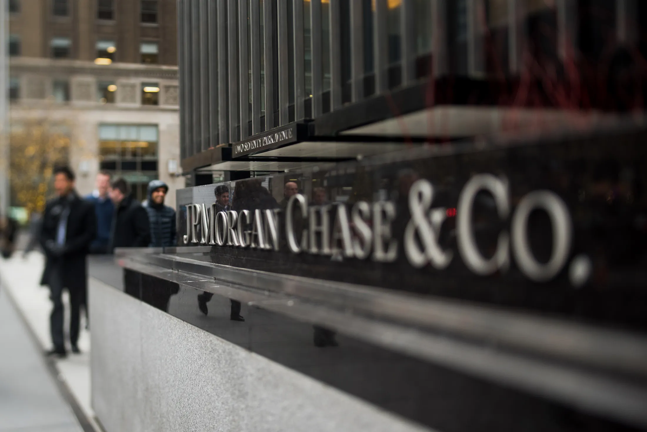 Pedestrians walk past JPMorgan Chase &amp; Co.
