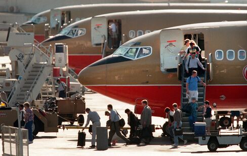 Passengers disembark from Southwest Airlines flights parked at Burbank Airport during the late after