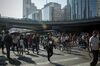 Pedestrians cross a road next to cyclists and other vehicles in the central business district in Beijing, China, on Friday, June 1, 2018. The People's Bank of China announced on Friday that it would add debt instruments tied to small-business and the green economy.