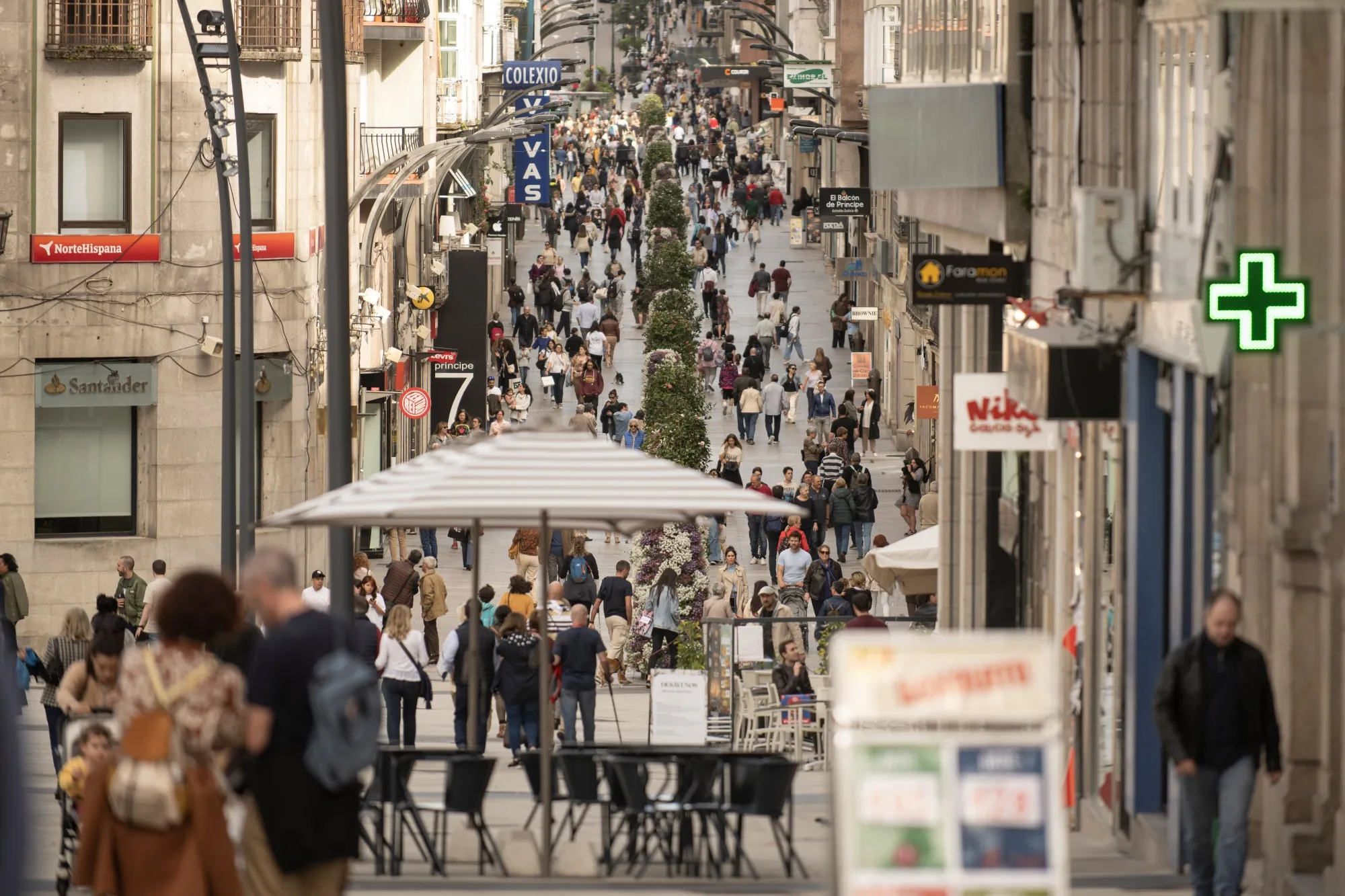 Shoppers on Rua do Principe retail street in Vigo, Spain.