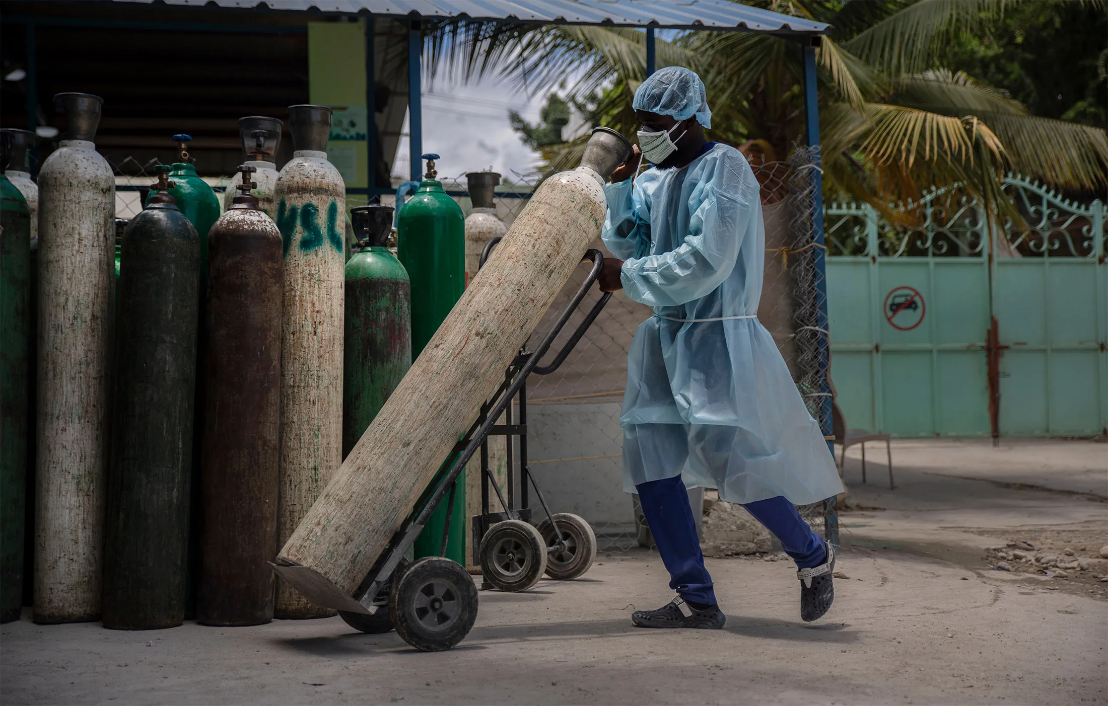 A hospital employee transports oxygen in Port-au-Prince, Haiti, on June 5.