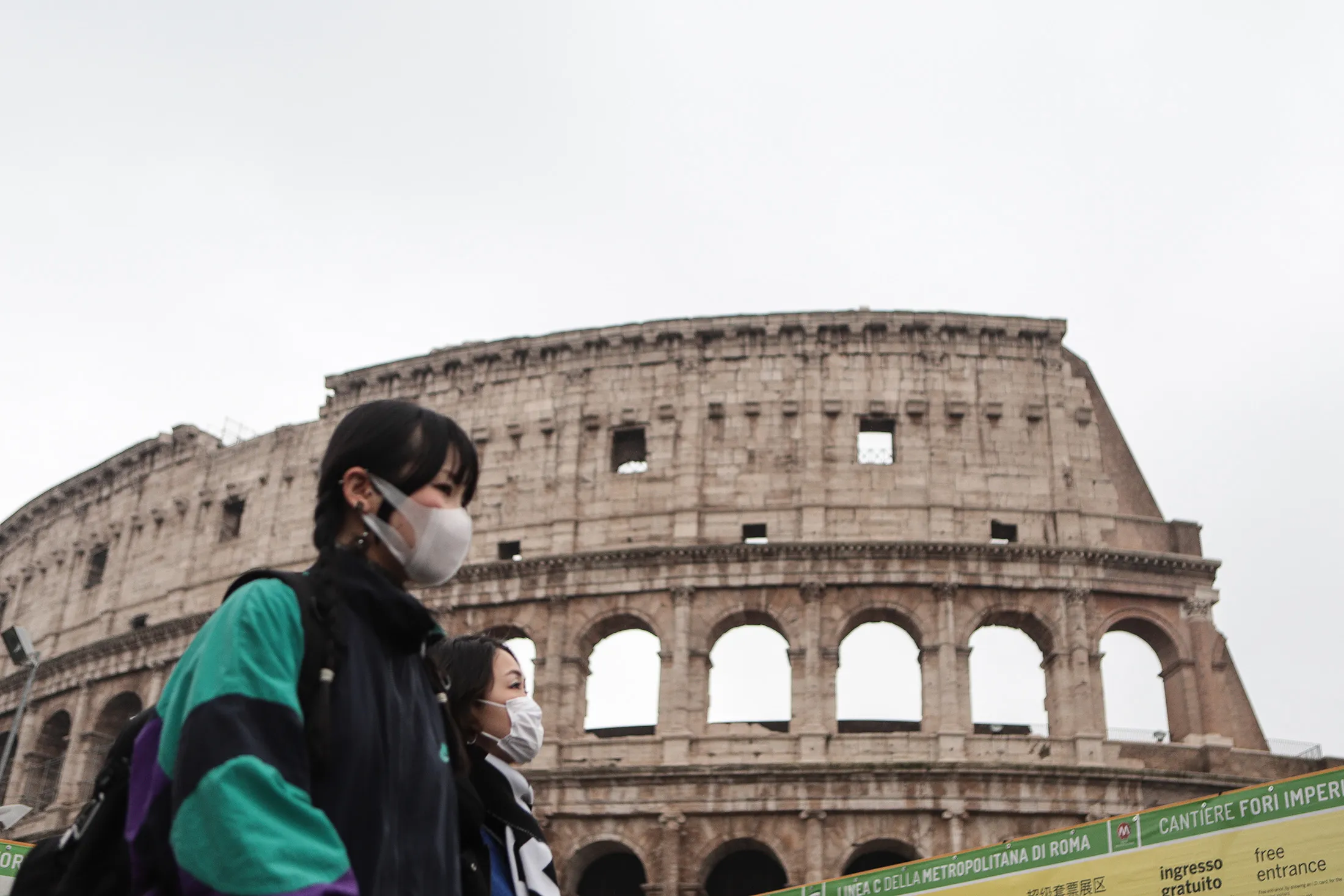 Tourist wearing a protective respiratory mask tour&nbsp;outside the Colosseo monument in Rome. on Feb. 1.