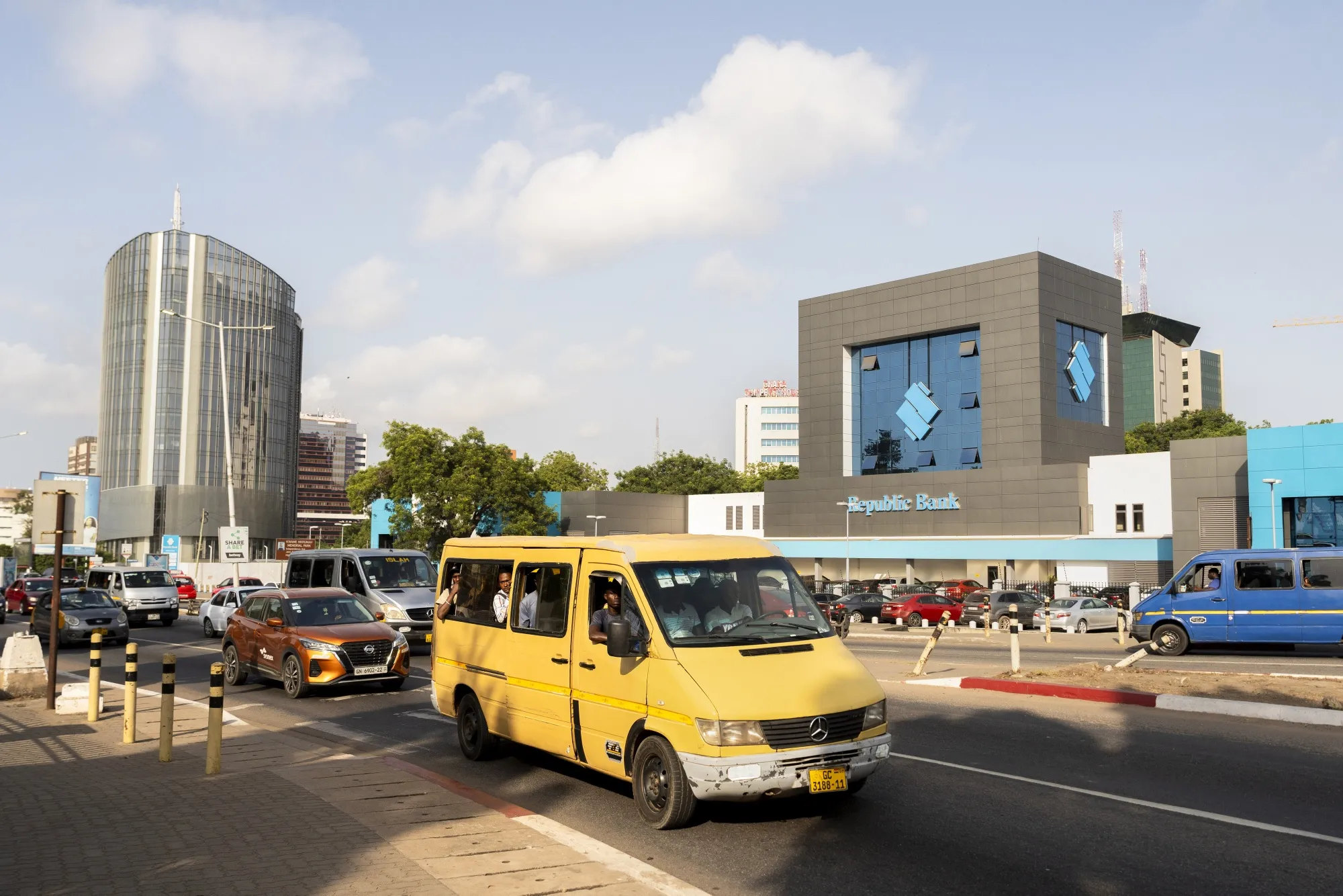 Traffic passes a Republic Bank Ghana Plc bank branch in Accra, Ghana.