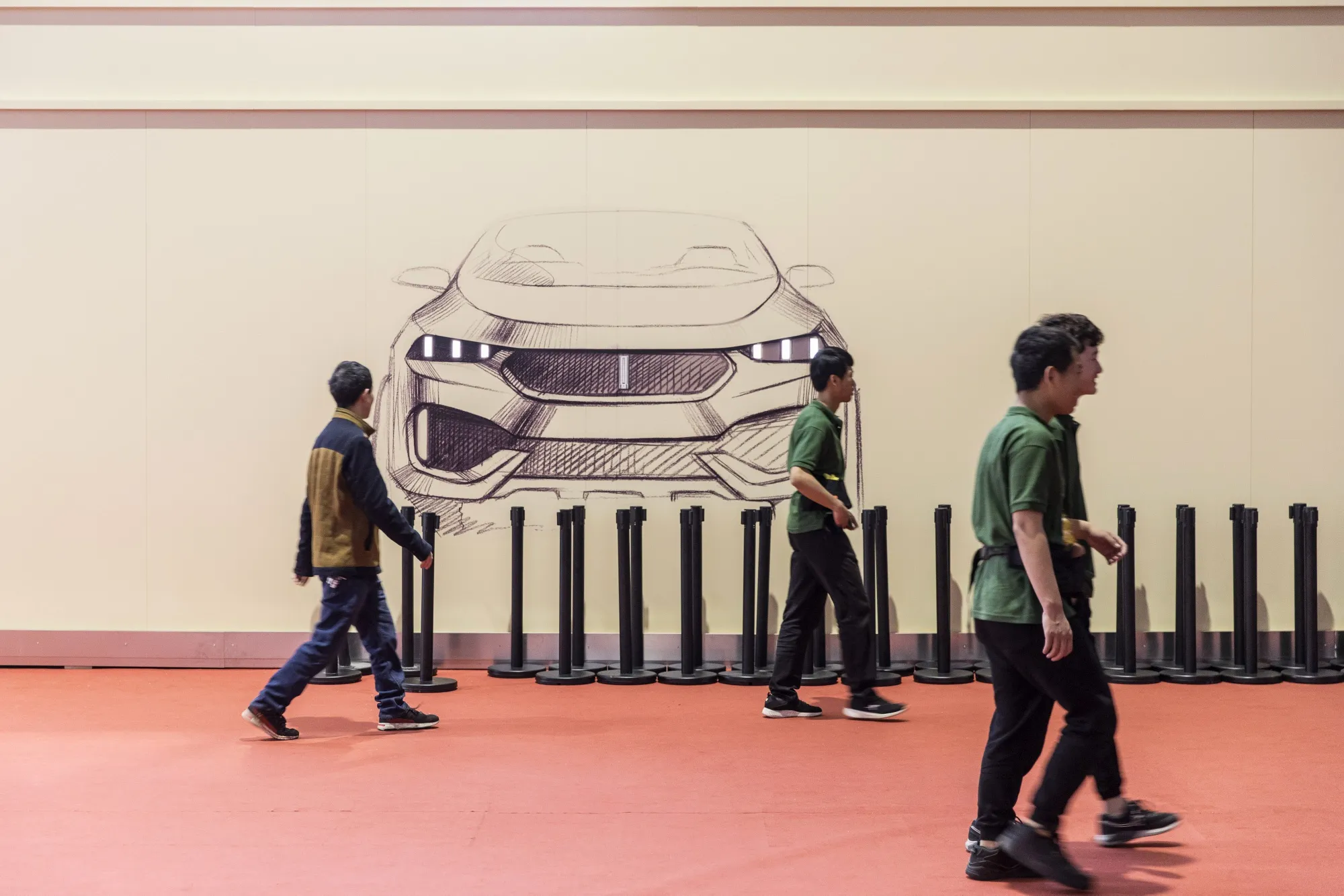 Attendees walk past a sketch of a WEY vehicle during Auto Shanghai 2019 show in April&nbsp;2019.&nbsp;
