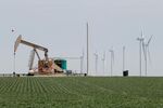 An oil derrick and wind turbines near Amarillo, Texas.