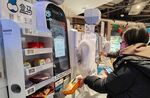 Customers scan food at a Freshippo store in Shanghai.