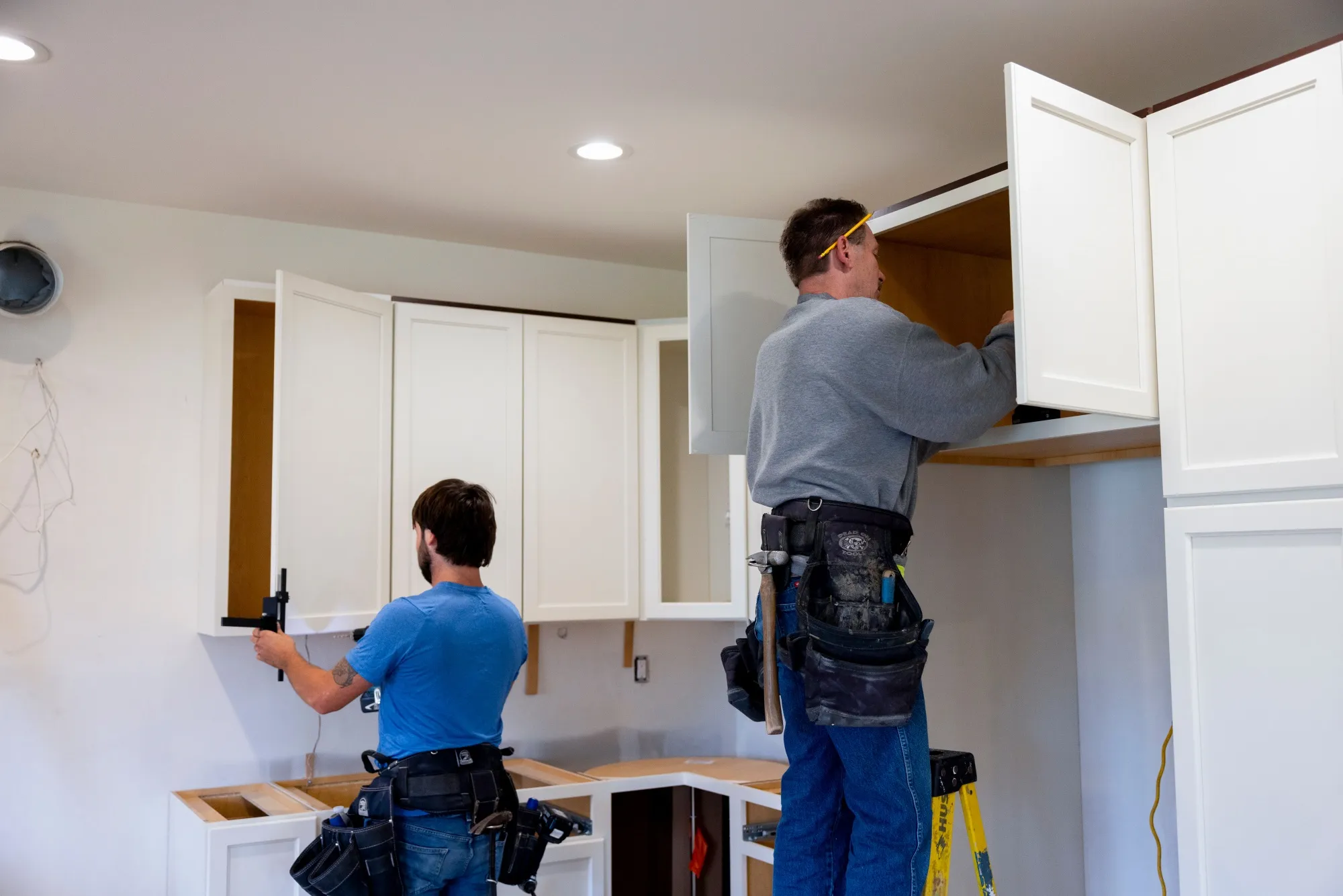 Workers install kitchen cabinets inside a home under construction&nbsp;in Loudonville, New York.
