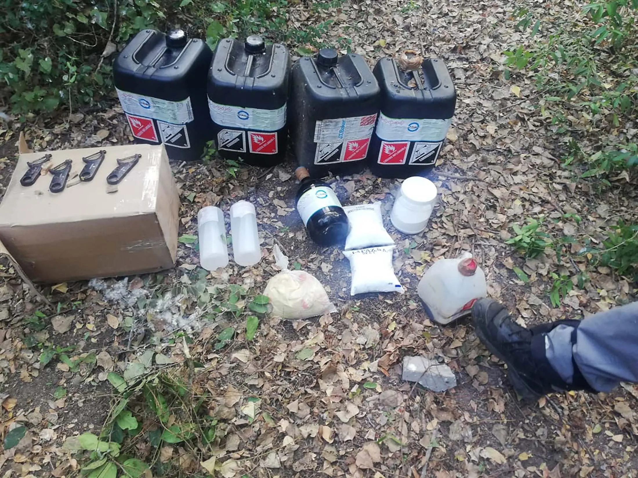 Police photos from a May 2019 bust in Sinaloa state. The jugs contain&nbsp;acetic anhydride.