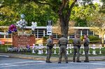 
Police officers stand near a makeshift memorial for the shooting victims at Robb Elementary School in Uvalde, Texas, on May 26, 2022.&nbsp;
