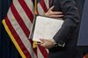 Jerome Powell, chairman of the U.S. Federal Reserve, carries his notes while exiting after a news conference.
