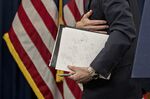 Jerome Powell, chairman of the U.S. Federal Reserve, carries his notes while exiting after a news conference.