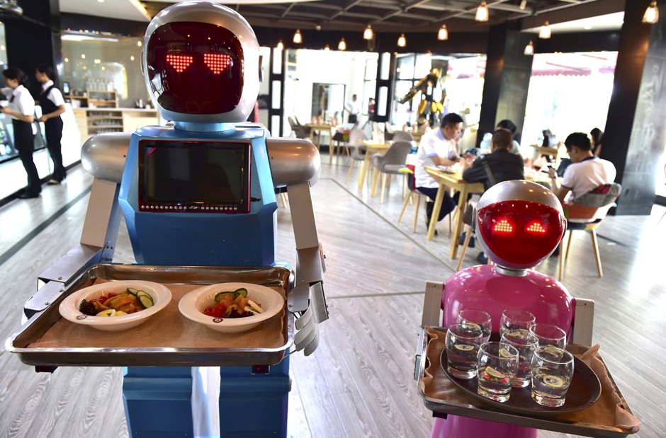 Robots carry trays at a restaurant in China in 2015.