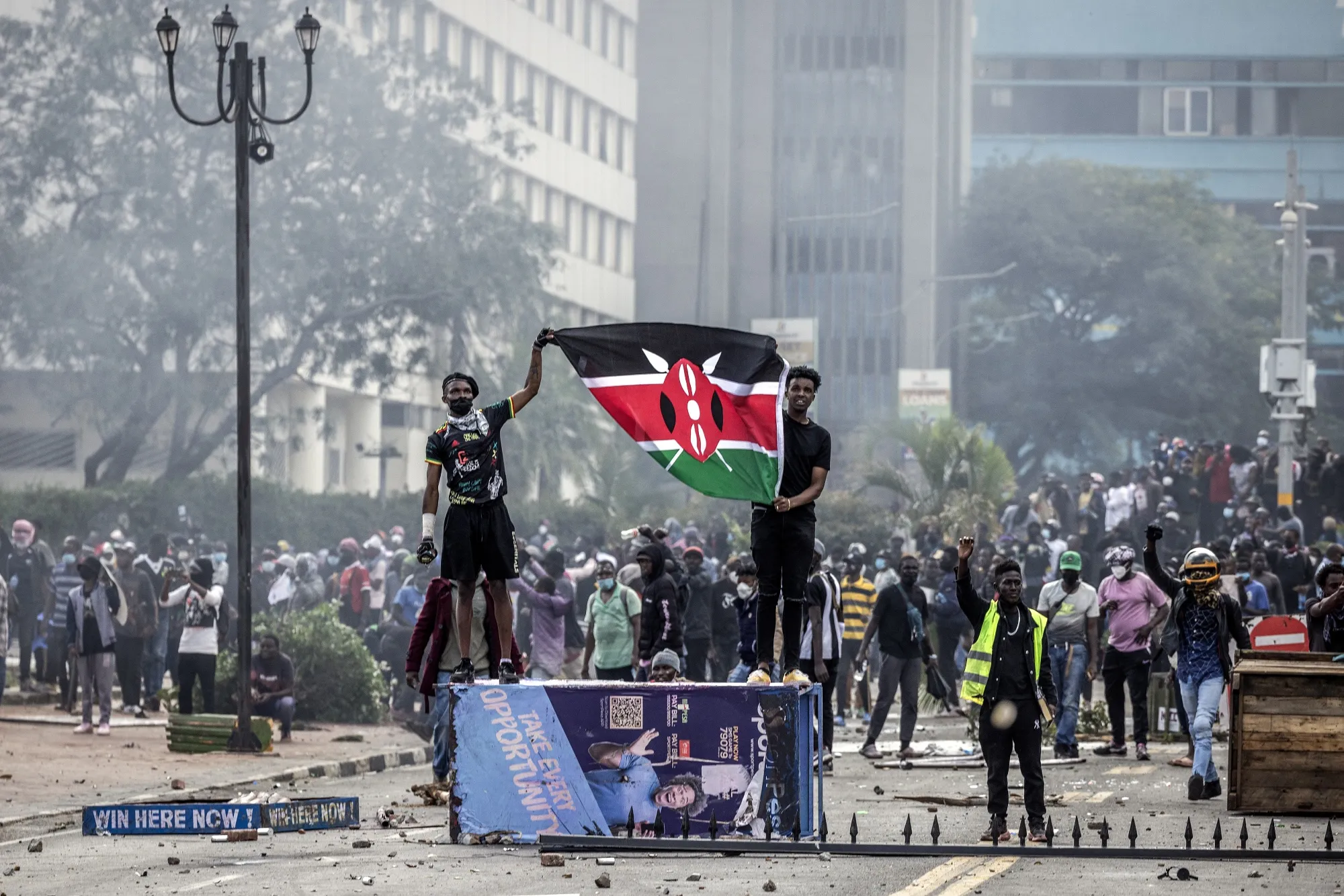 Protesters hold a Kenyan flag outside parliament in Nairobi on June 25.