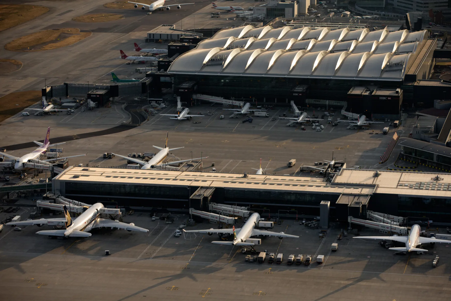 A South African Airways aircraft, center, sits at a passenger terminal building at London Heathrow Airport.
