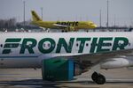 A Frontier Airlines airplane taxis past a Spirit Airlines aircraft at Indianapolis International Airport in&nbsp;Indiana.