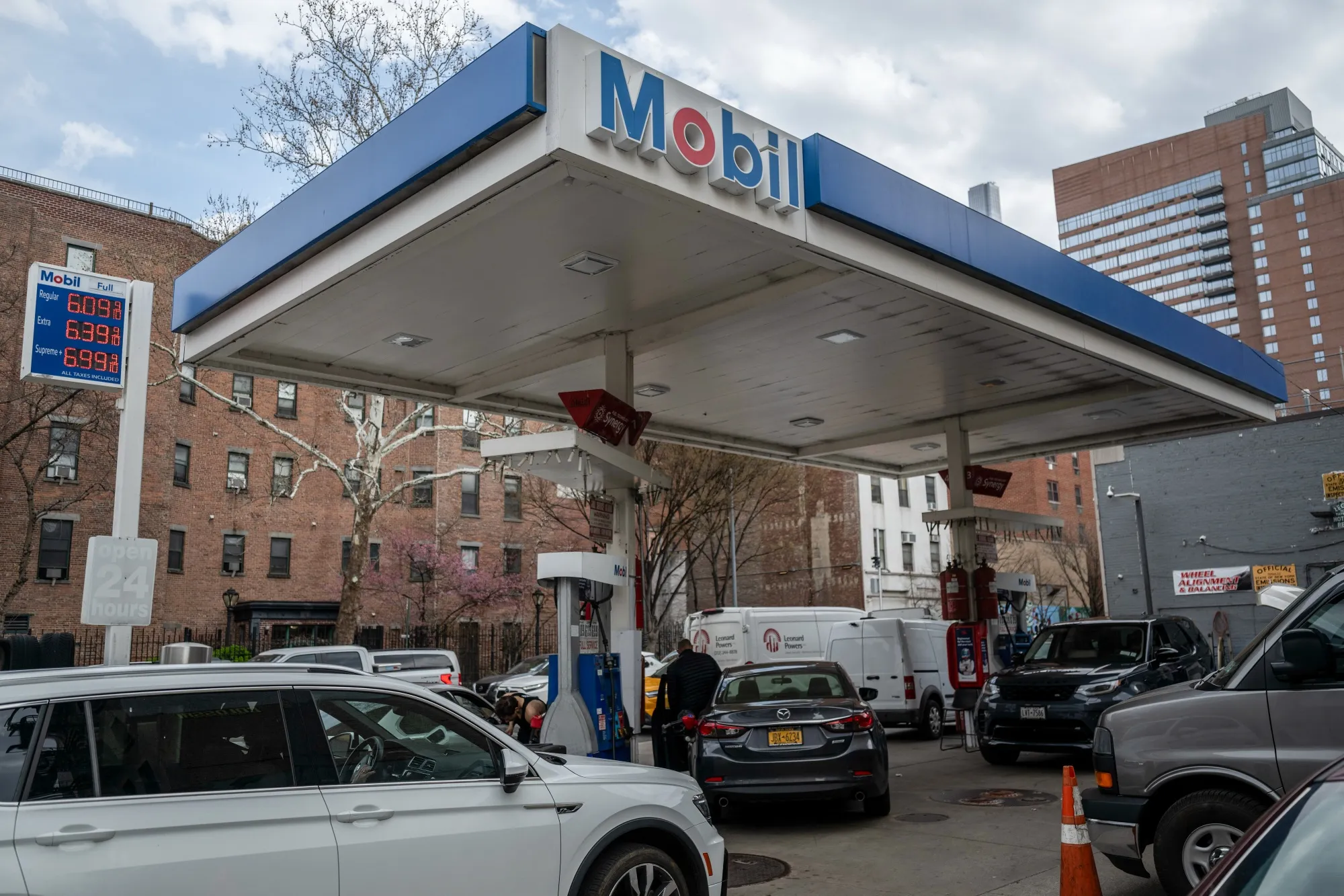 Drivers refuel their vehicles&nbsp;at a Mobil gas station in New York.