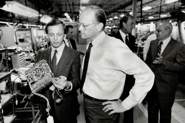 Ford boss visits: Donald Petersen; right; president of U. S. Ford Motor Co.; tours a Philco-Ford of