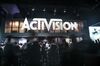 Attendees walk past Activision Blizzard Inc. signage during the E3 Electronic Entertainment Expo in Los Angeles.