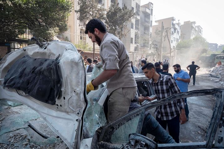 Damaged and destroyed buildings and vehicles in Tehran on June 13.