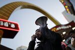 A man protesting for a $15 an hour wage in front of a McDonald's in Las Vegas