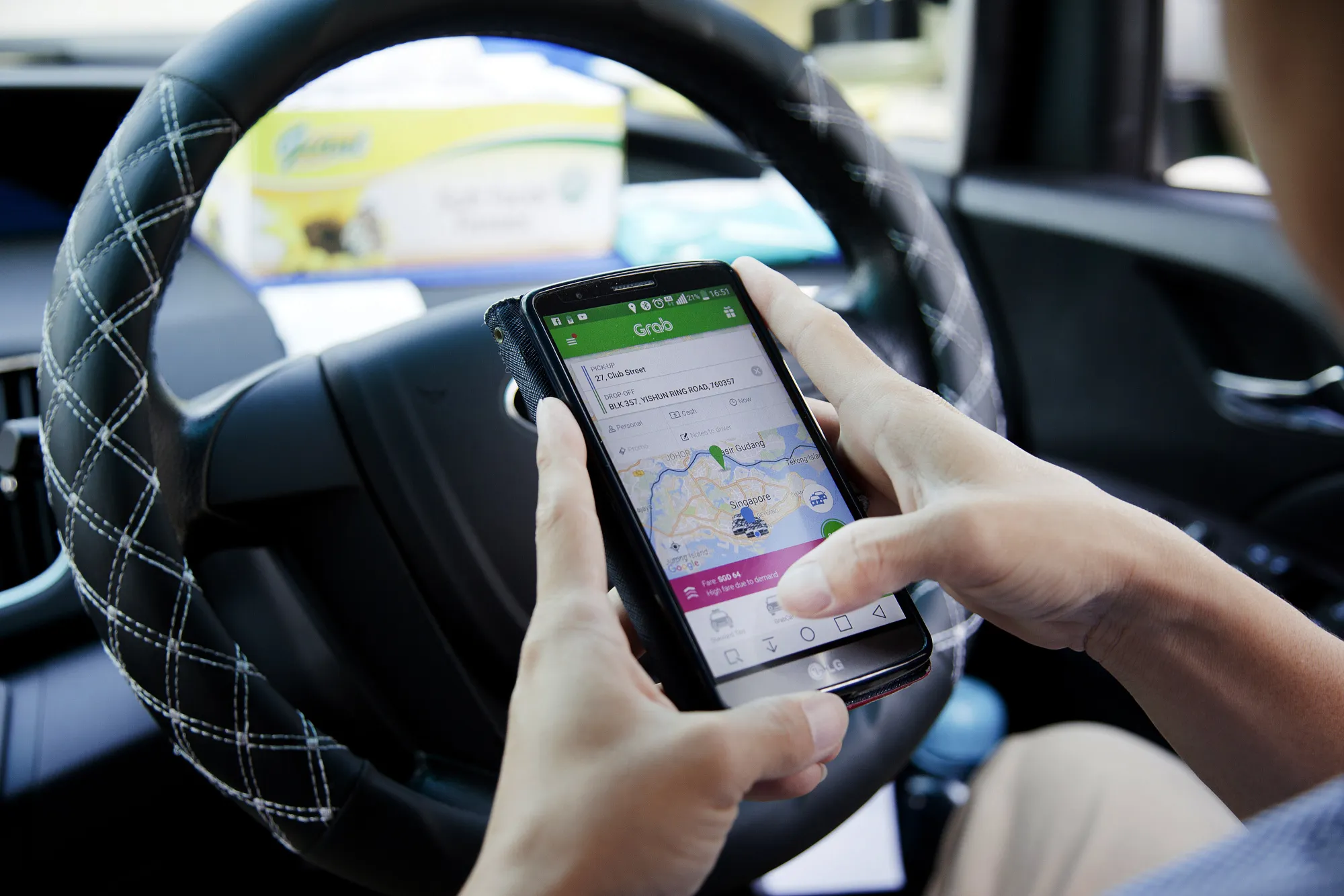 A driver uses the Grab app in Singapore.&nbsp;