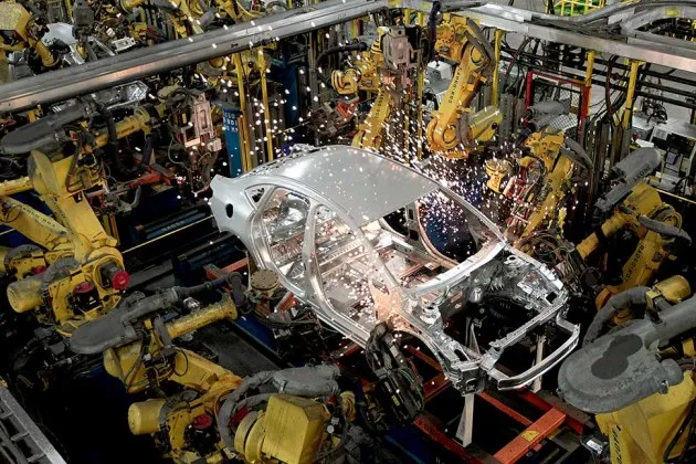 Welding Chevrolet Sonics and Buick Veranos at GM's assembly plant in Lake Orion, Mich.