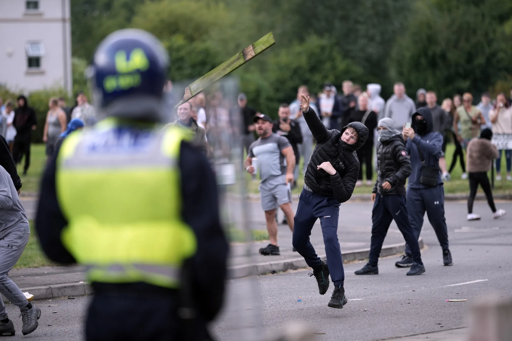 Riot police officers patrol as anti-migration protesters gather in Rotherham, UK on Aug. 4.