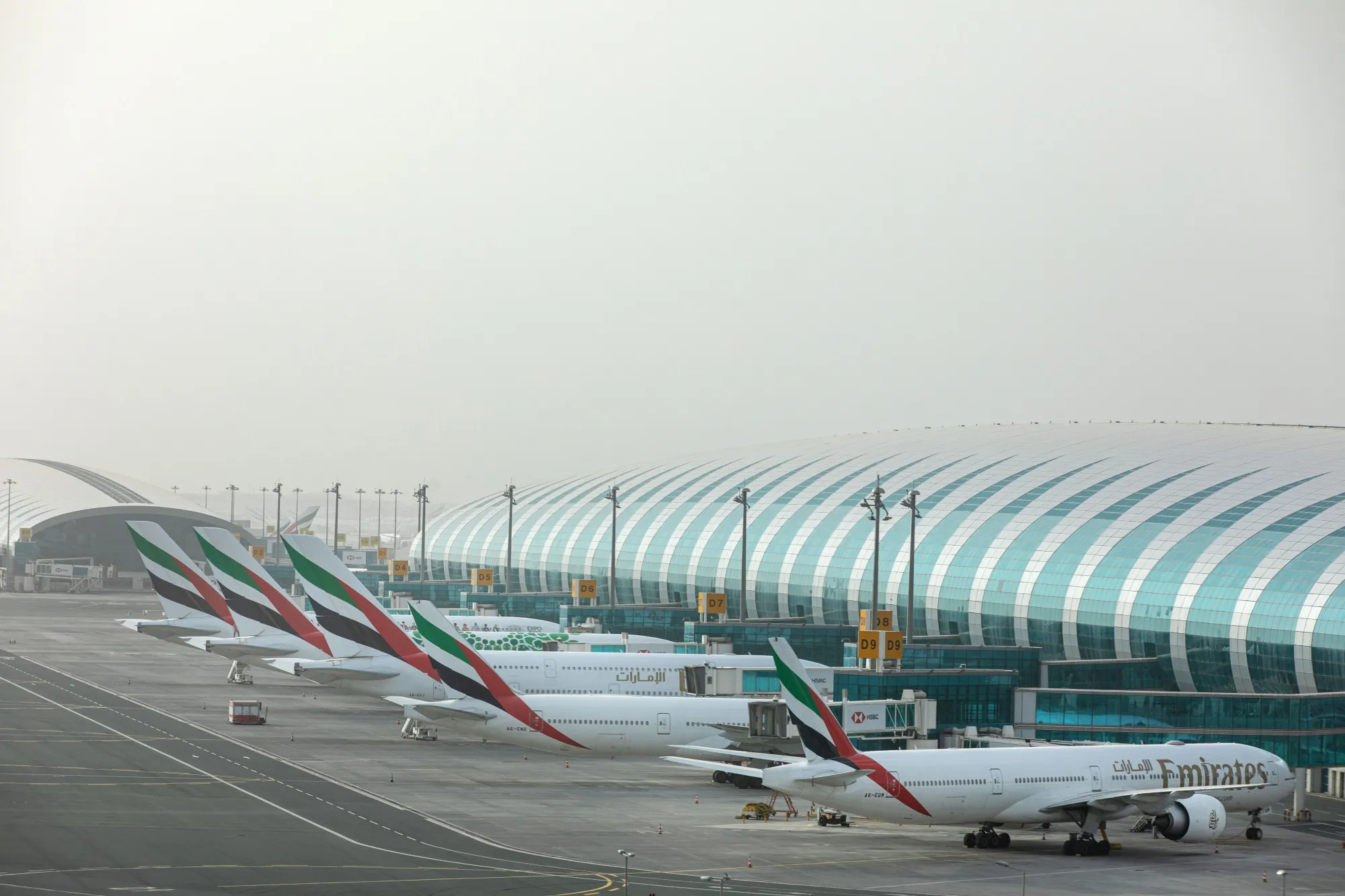 Emirates aircraft stand at the terminal at Dubai International Airport.