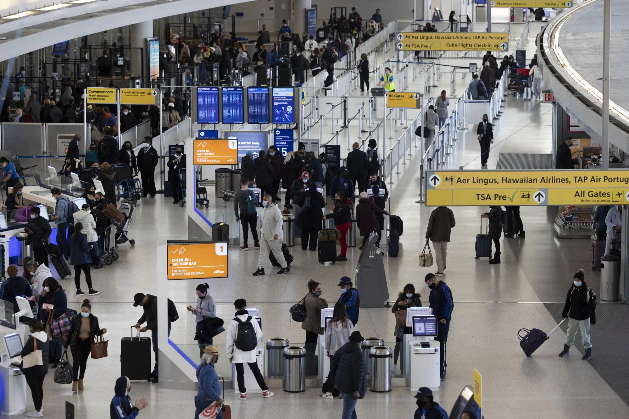Travelers walk through Terminal 4 at John F. Kennedy International Airport in New York.