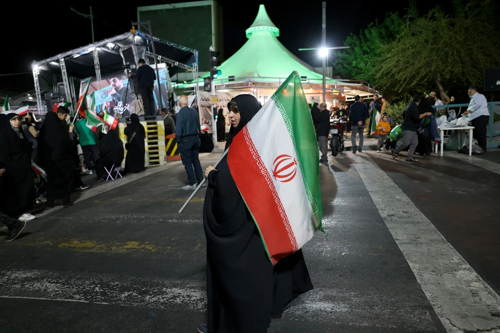 A woman holds an Iranian flag during a rally in Tehran on April 27.
