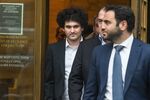 Sam Bankman-Fried, left, departs from court in New York, on Jan. 3.