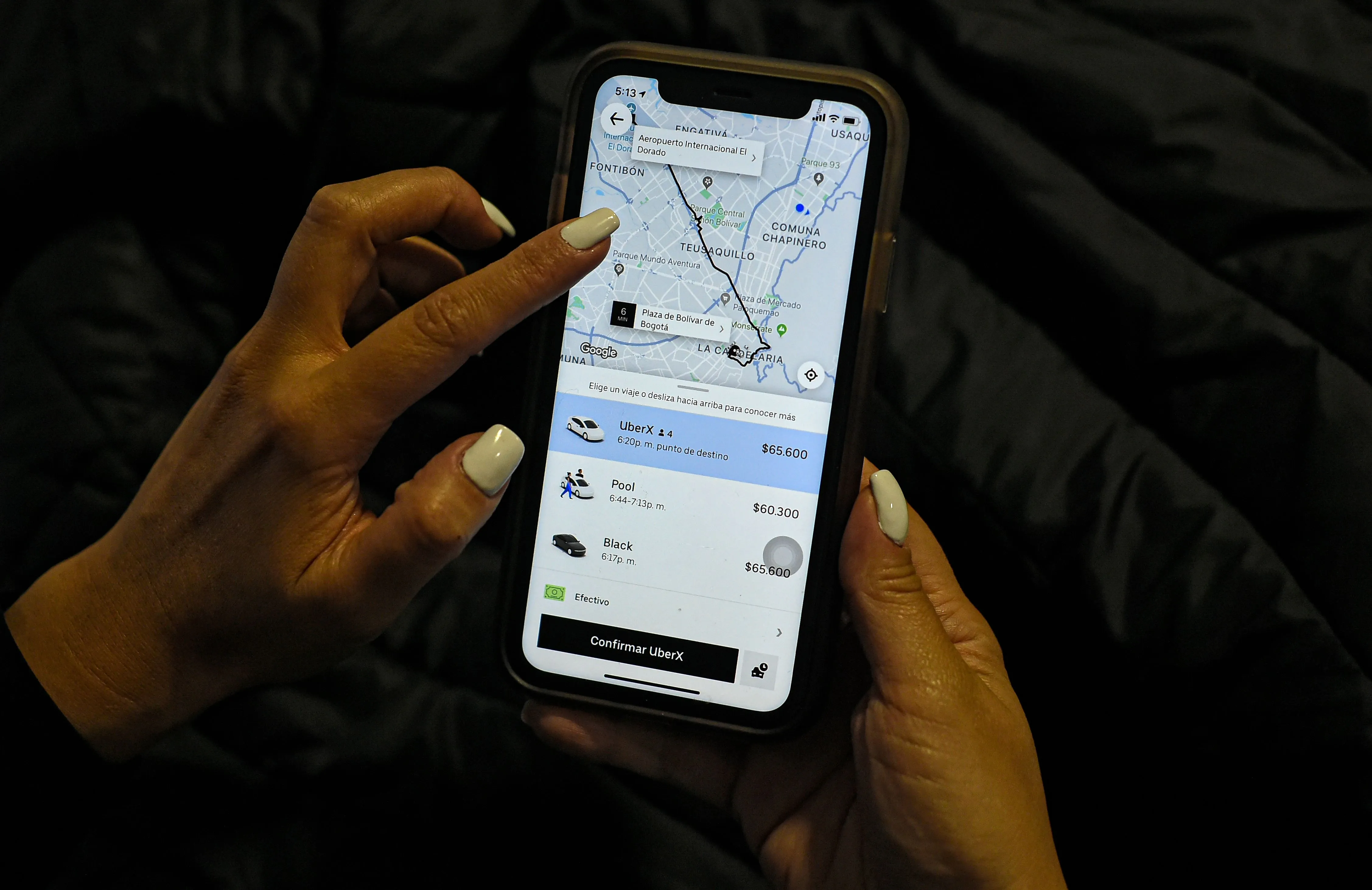 A woman checks her Uber app&nbsp;in Bogota, Colombia.