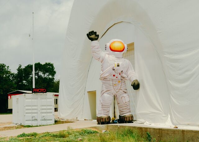 A spaceman blowup doll outside the inflatable office space at the center of Proto-Town. 