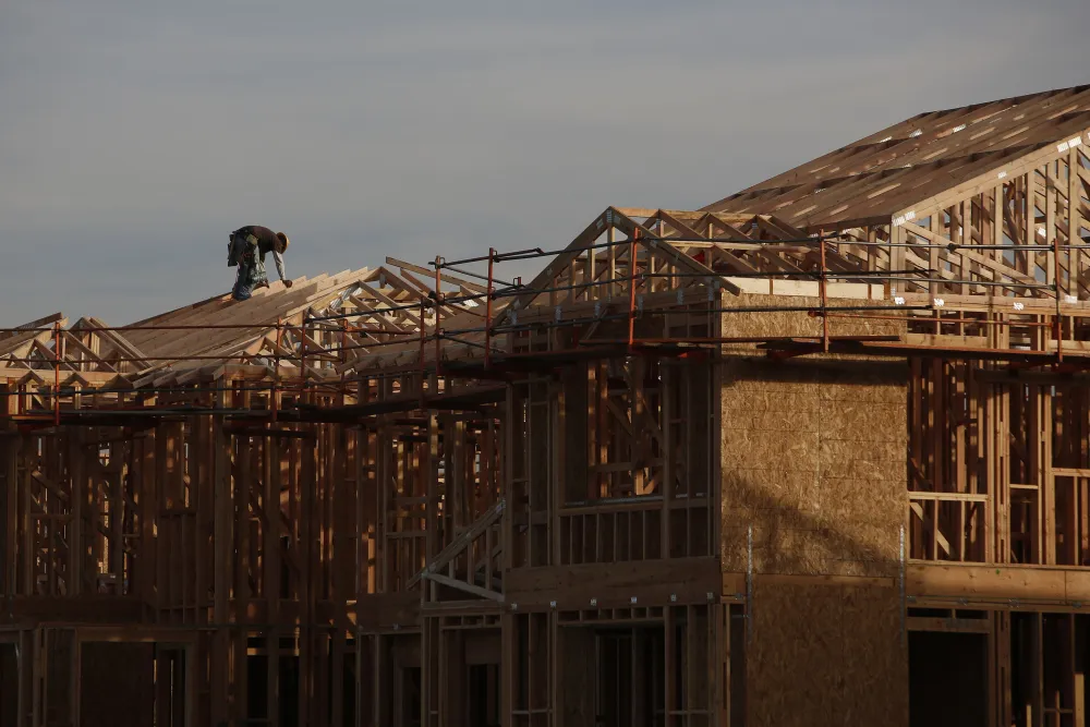 Workers frame new homes in Lake Forest, California.