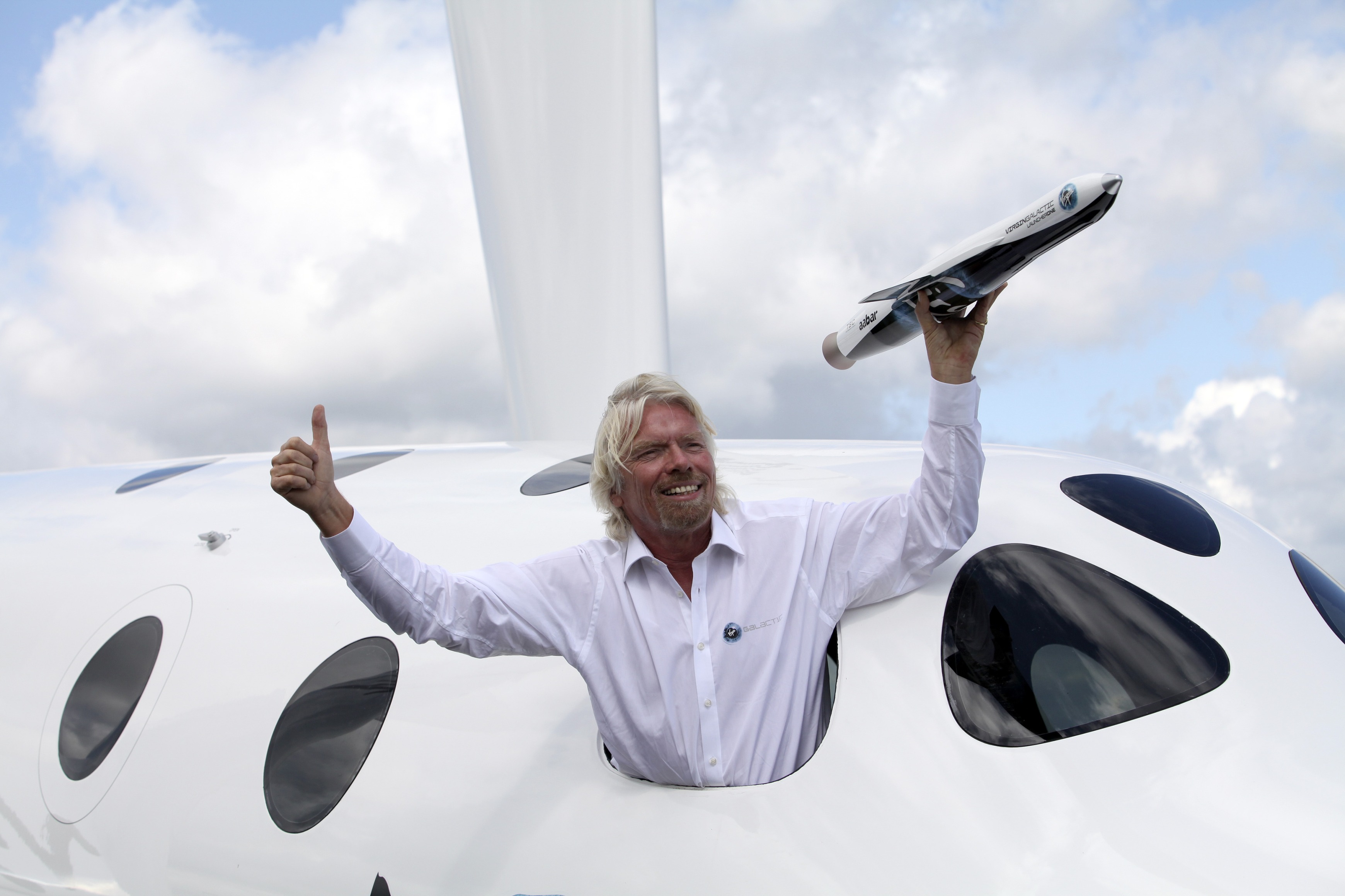 Richard Branson poses from the window of Virgin Galactic’s SpaceShipTwo in 2012.