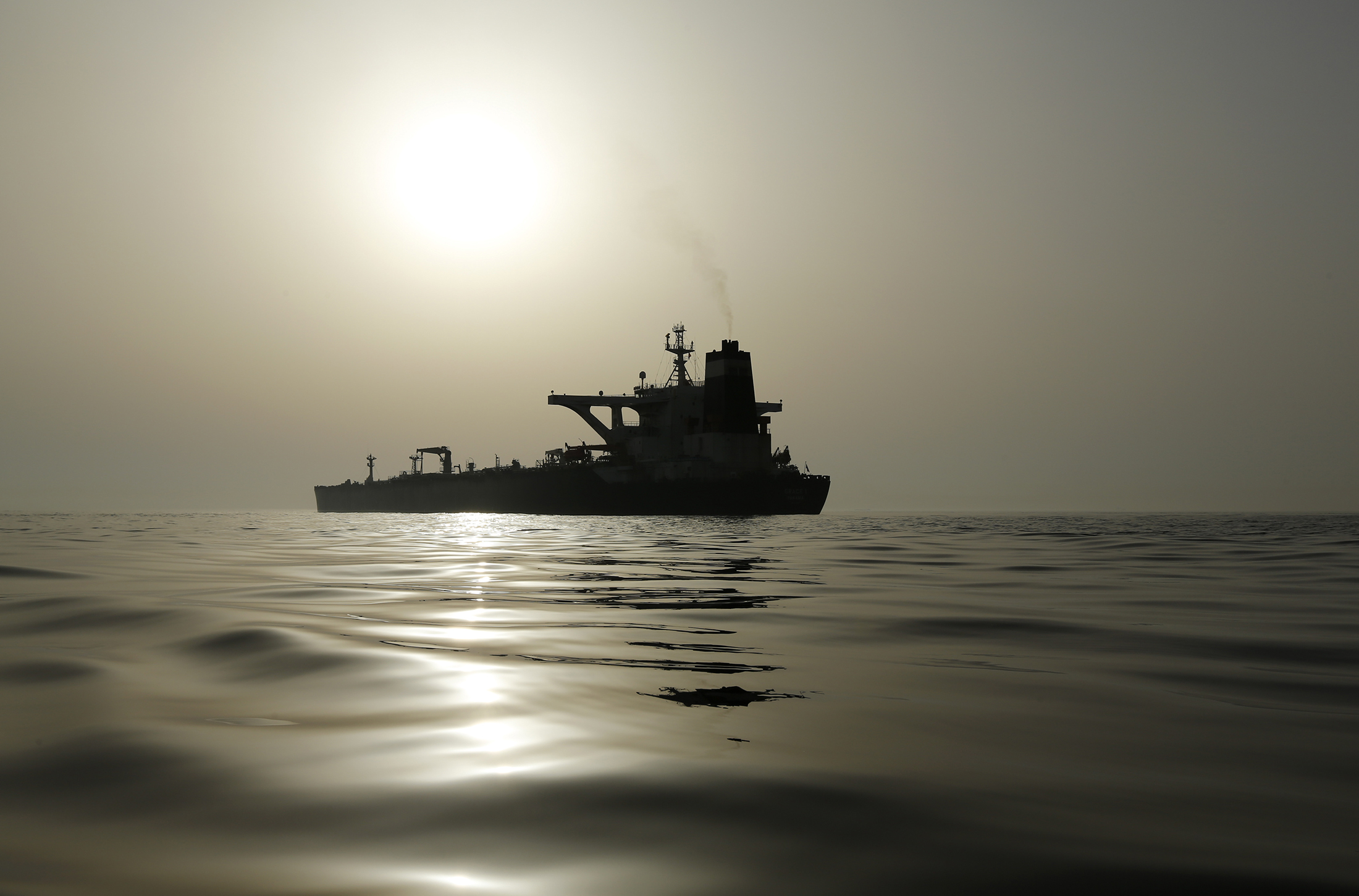 The impounded Iranian crude oil tanker, Grace 1, is silhouetted as it sits anchored off the coast of Gibraltar on Saturday, July 20, 2019. Tensions have flared in the Strait of Hormuz in recent weeks as Iran resists U.S. sanctions that are crippling its oil exports and lashes out after the seizure on July 4 of one of its ships near Gibraltar.