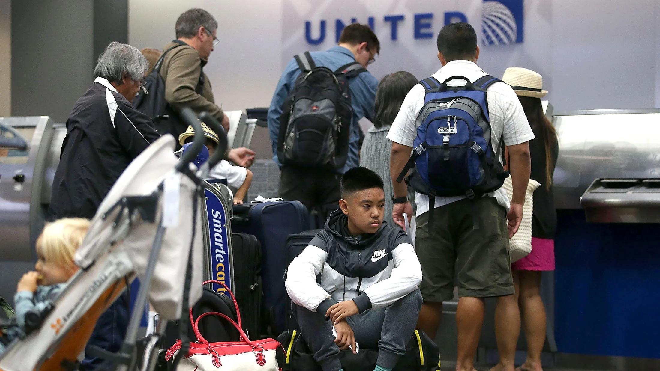 United Airlines passengers wait in line at San Francisco International Airport on July 8, when a massive computer glitch grounded flights.
