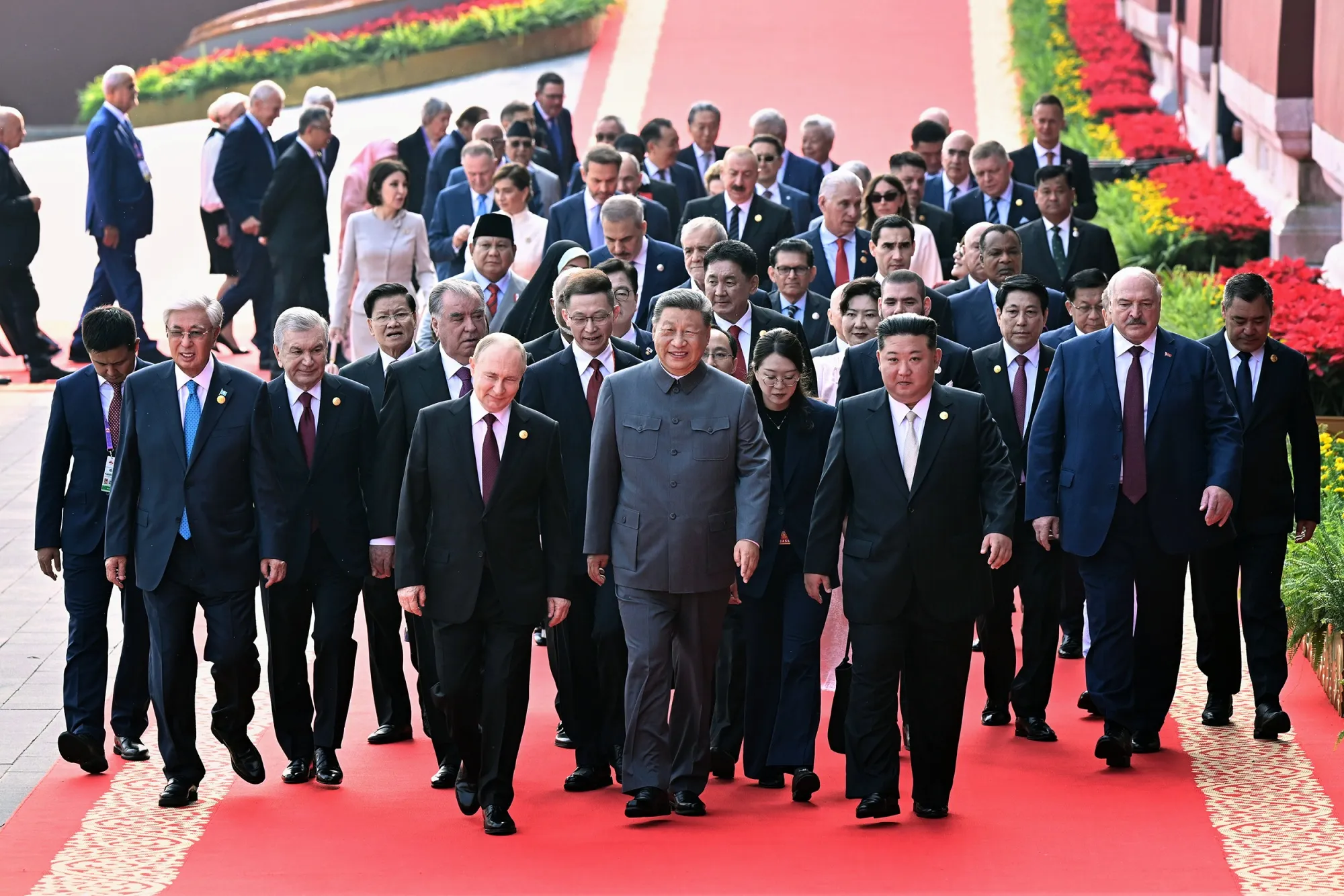 In this photo released by Xinhua News Agency, Xi Jinping, center,&nbsp;Vladimir Putin, center left,&nbsp;Kim Jong Un, center right, and other foreign leaders make their way to the&nbsp;Tiananmen Rostrum ahead of a ceremon&nbsp;in Beijing,&nbsp;on Sept. 3.
