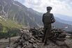 An Indian soldier stands guard at the Line of Control in May.