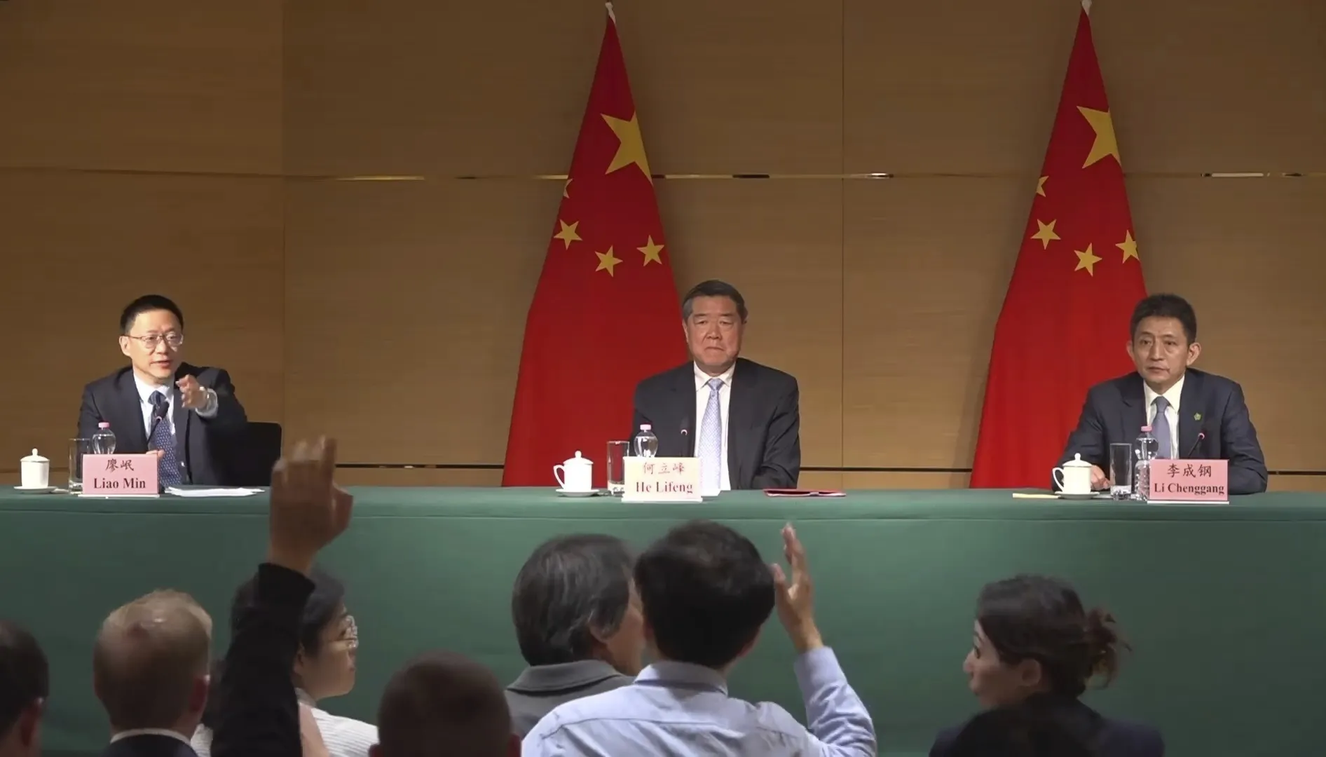 Liao Min, left, He Lifeng, center, and Li Chenggang at a news conference in Geneva on May 11.