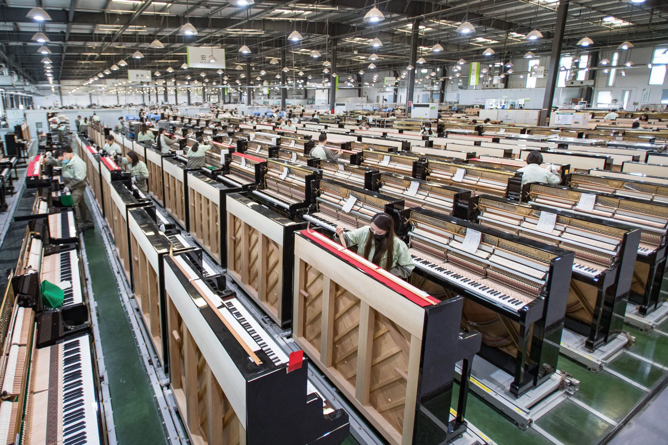 Workers adjust&nbsp;pianos at a&nbsp;factory in Yichang, China, last year.