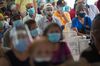 People wait to receive a dose of the Sputnik V Covid-19 vaccine at a clinic in Caracas, on April 9.