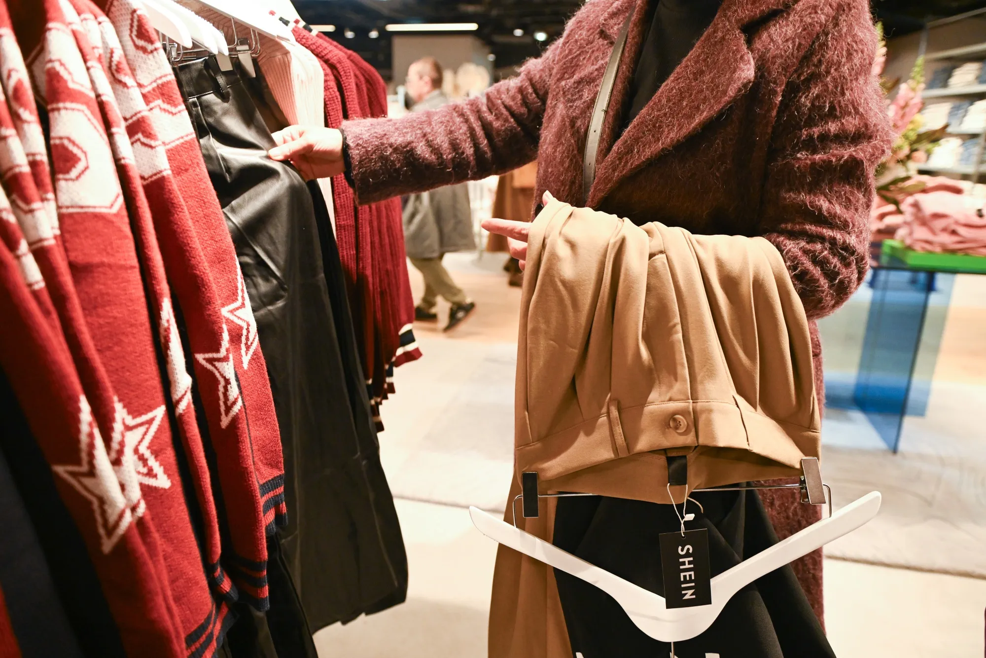 A shopper browses clothing at Shein's new Paris store.