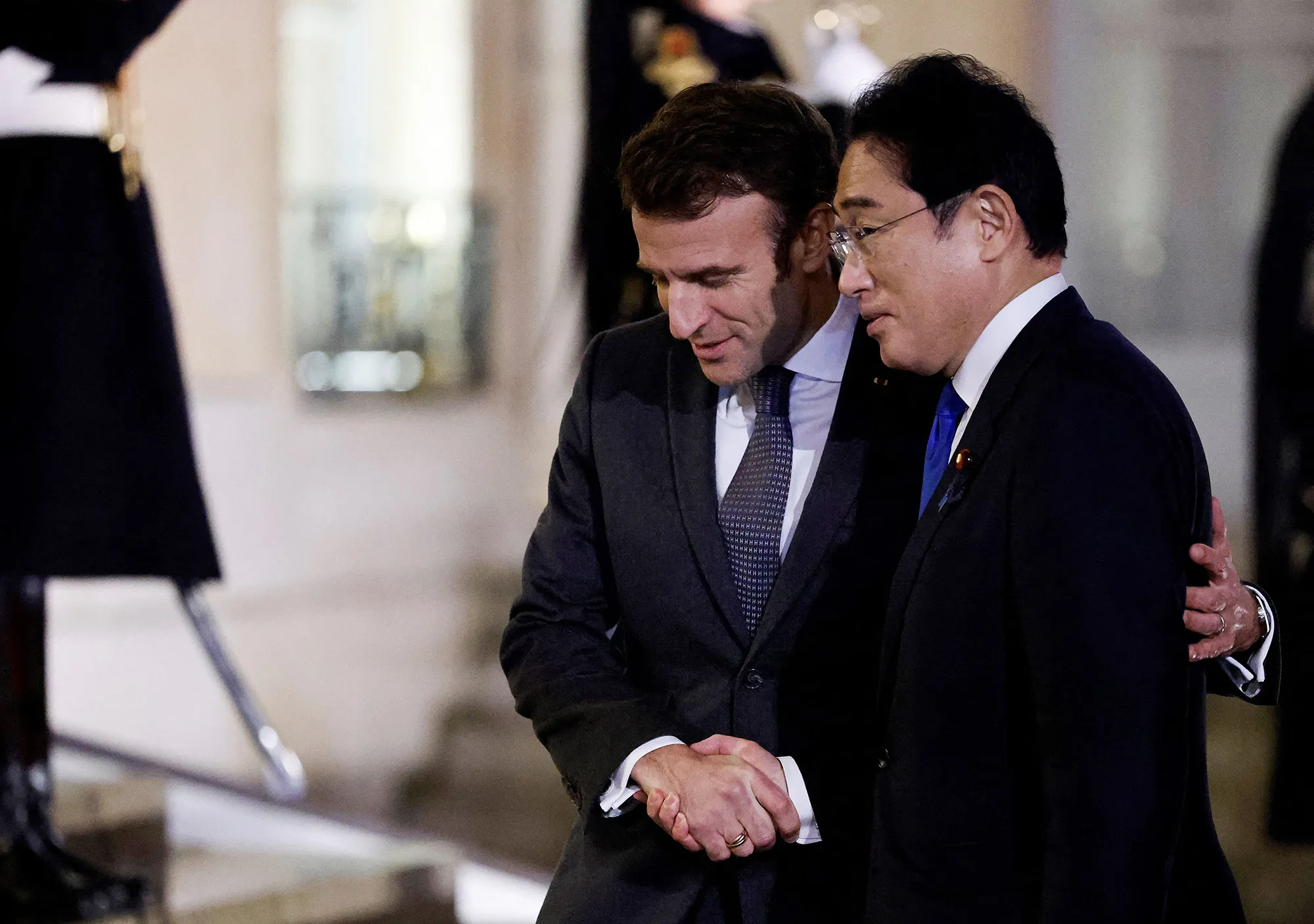 Emmanuel Macron welcomes Fumio Kishida as he arrives for a meeting at the Elysee Palace in Paris on Jan. 9.