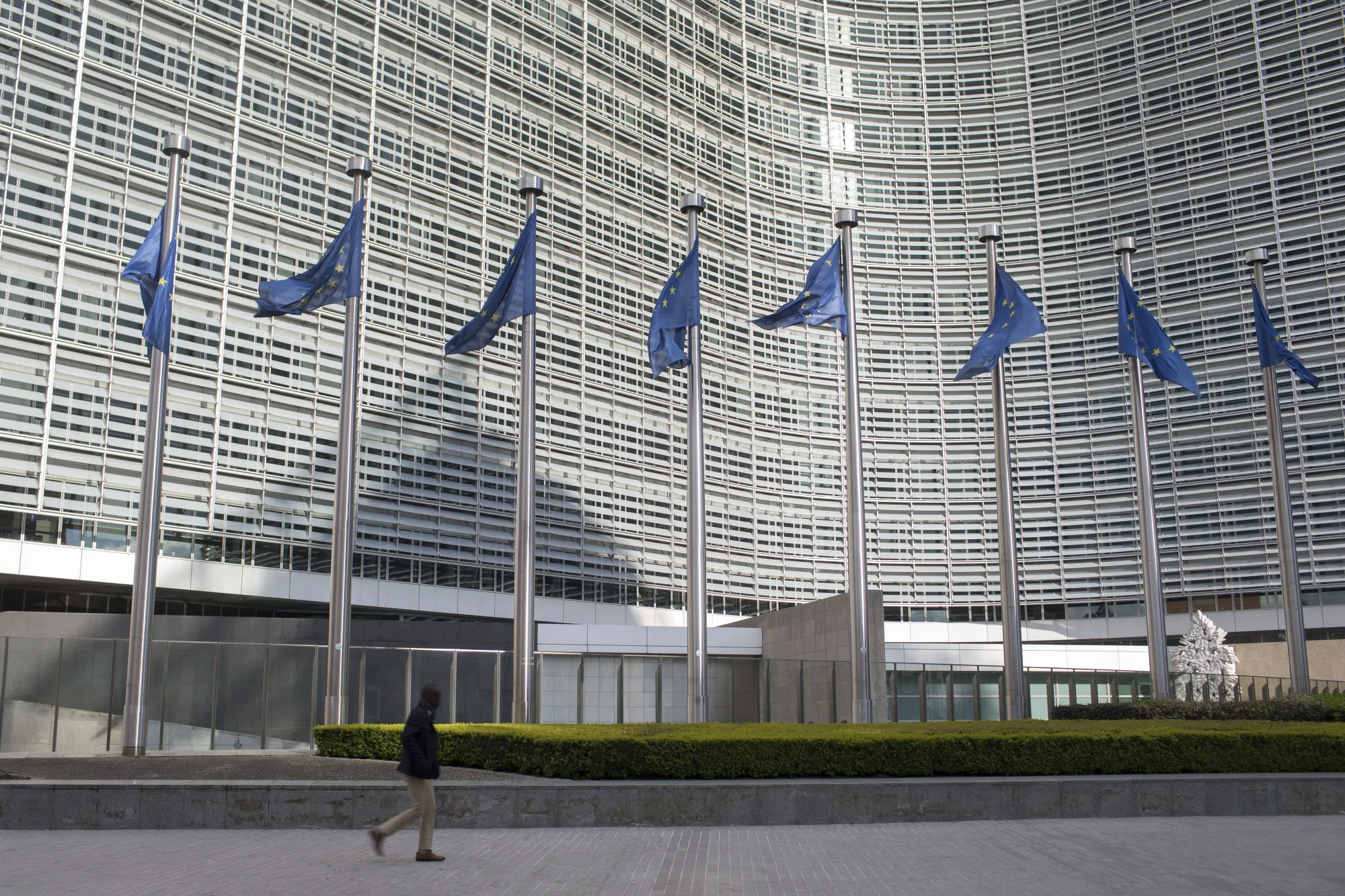 A pedestrian passing the European Commission building in Brussels, Belgium.