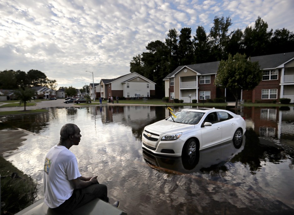 A man looks out at the flooded entrance to his apartment complex in Fayetteville, N.C., in the aftermath of Hurricane Florence.