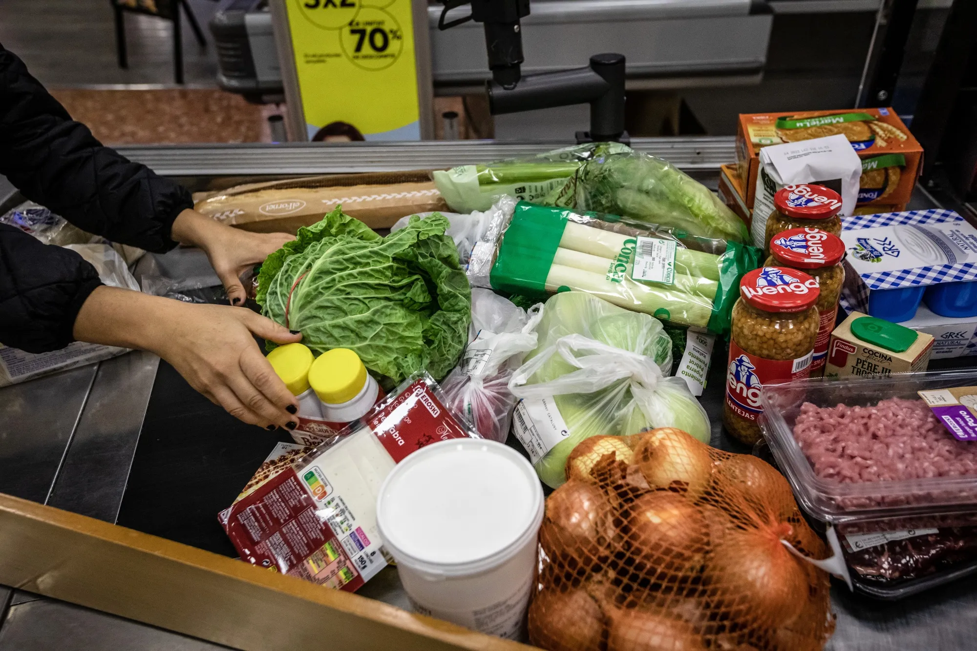 A customer purchases groceries at&nbsp;a supermarket in Barcelona, Spain.