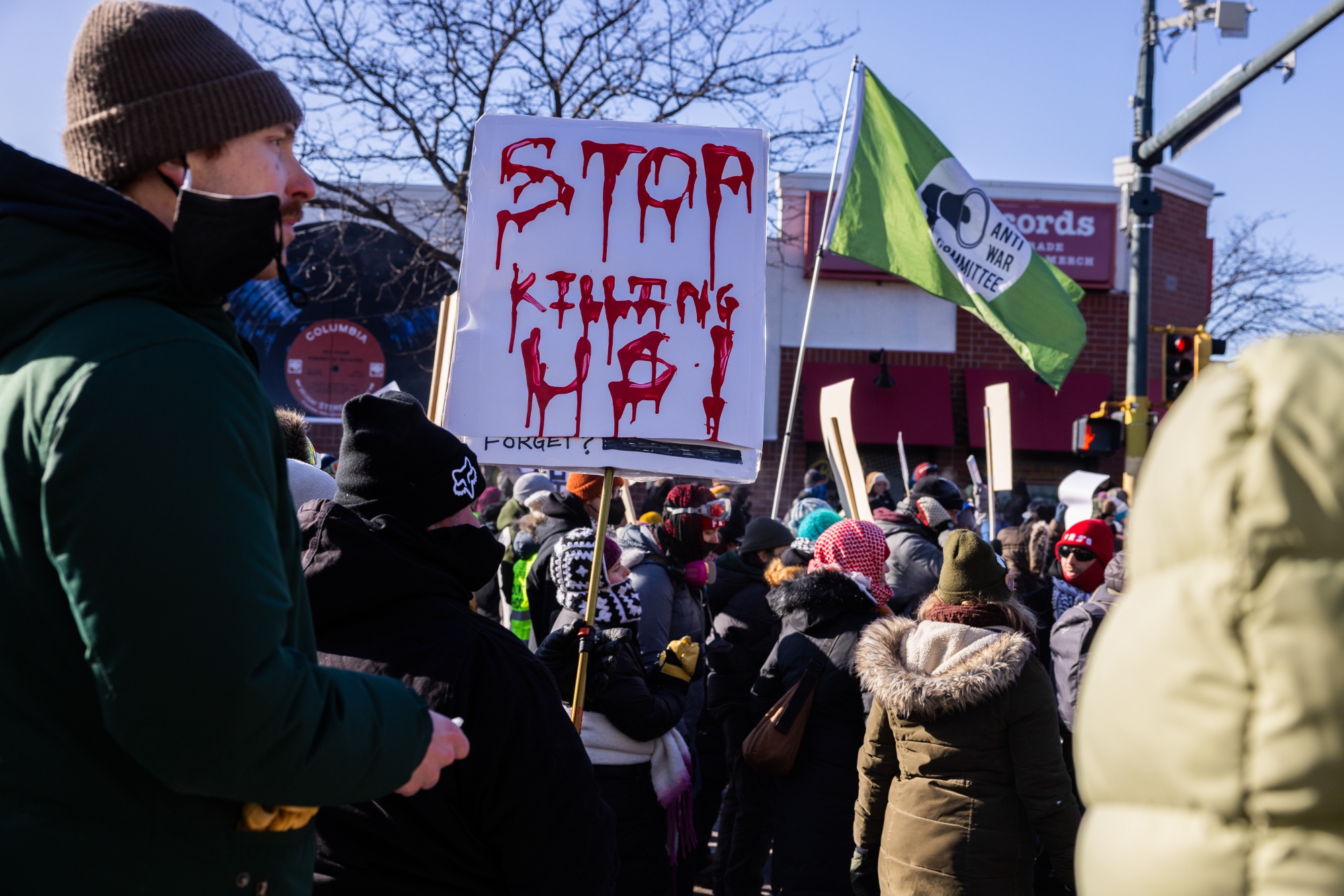 Residents hold a sign near the scene of a shooting by a federal law enforcement agent in Minneapolis, Minnesota, US, on Saturday, Jan. 24, 2026. A Border Patrol agent shot and killed a man believed to be a US citizen in Minneapolis on Saturday, the latest violent incident by law enforcement that has sparked widespread protests and condemnations by state and local officials. Photographer: Jaida Grey Eagle/Bloomberg