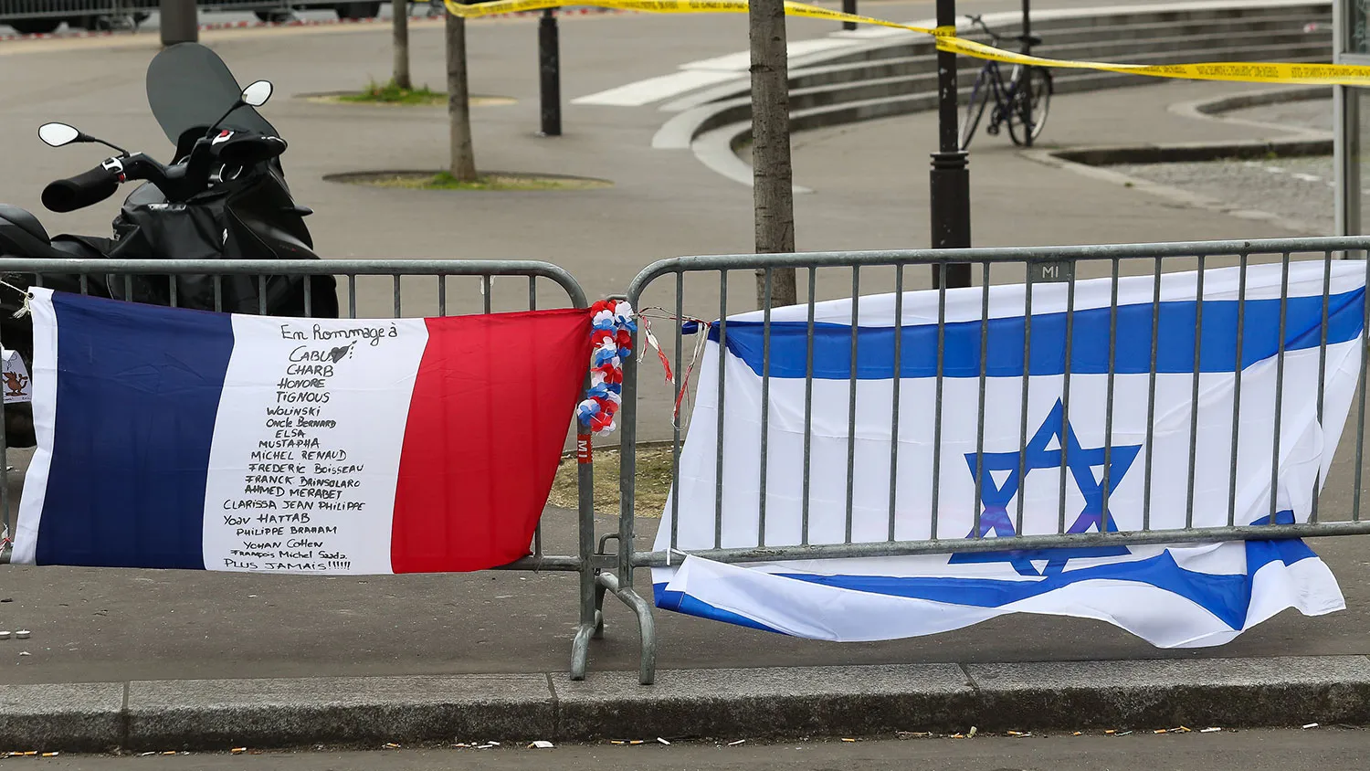 Tribute flags are left in the area while Benjamin Netanyahu, Prime Minister of Israel, pays his respects at the Hyper Cacher following the recent terrorist attacks on January 12, 2015 in Paris, France.
